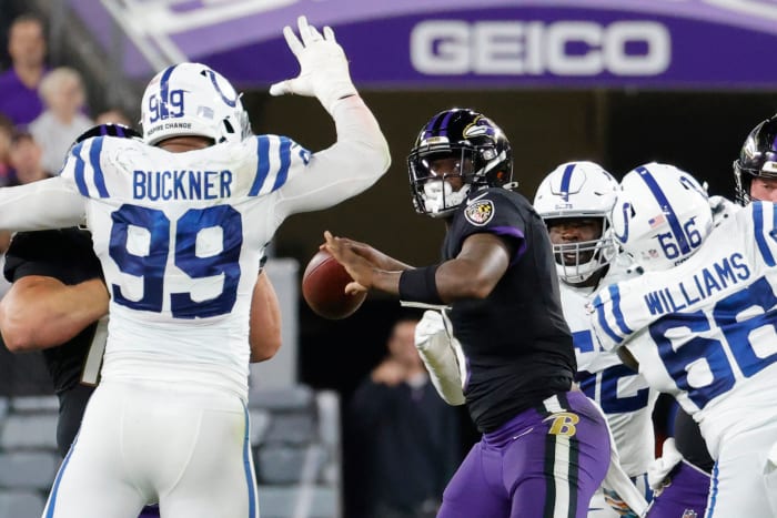 Oct 11, 2021; Baltimore, Maryland, USA; Baltimore Ravens quarterback Lamar Jackson (8) throws a touchdown pass to Baltimore Ravens wide receiver Marquise Brown (not pictured) under pressure from Indianapolis Colts defensive tackle DeForest Buckner (99) during the third quarter at M&T Bank Stadium. Mandatory Credit: Geoff Burke-USA TODAY Sports